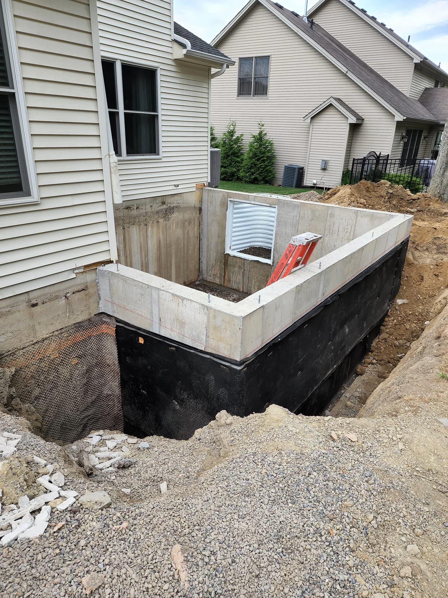 New concrete foundation with waterproofing and egress well in Buffalo