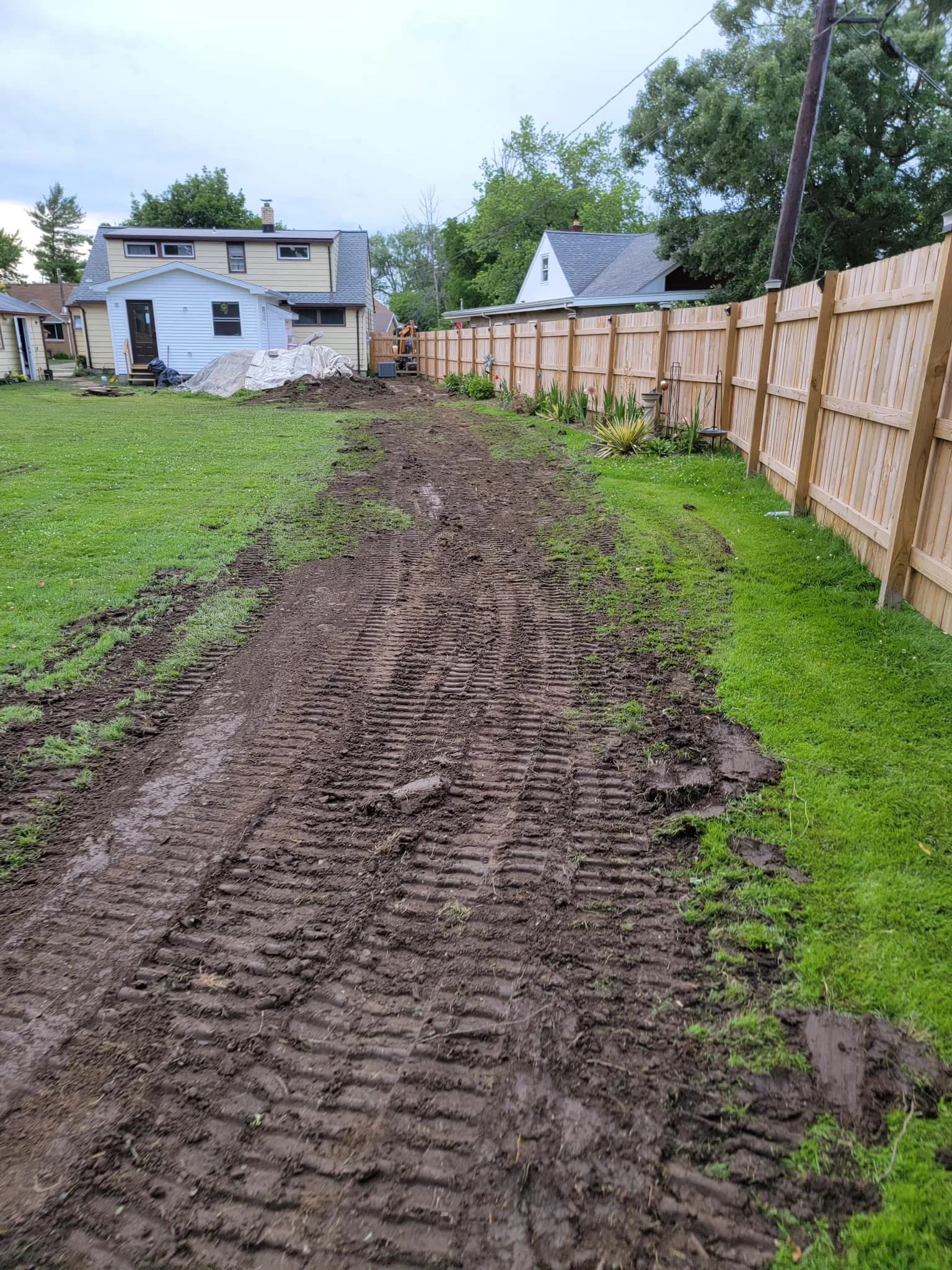 Post-excavation muddy tracks in Western New York residential backyard