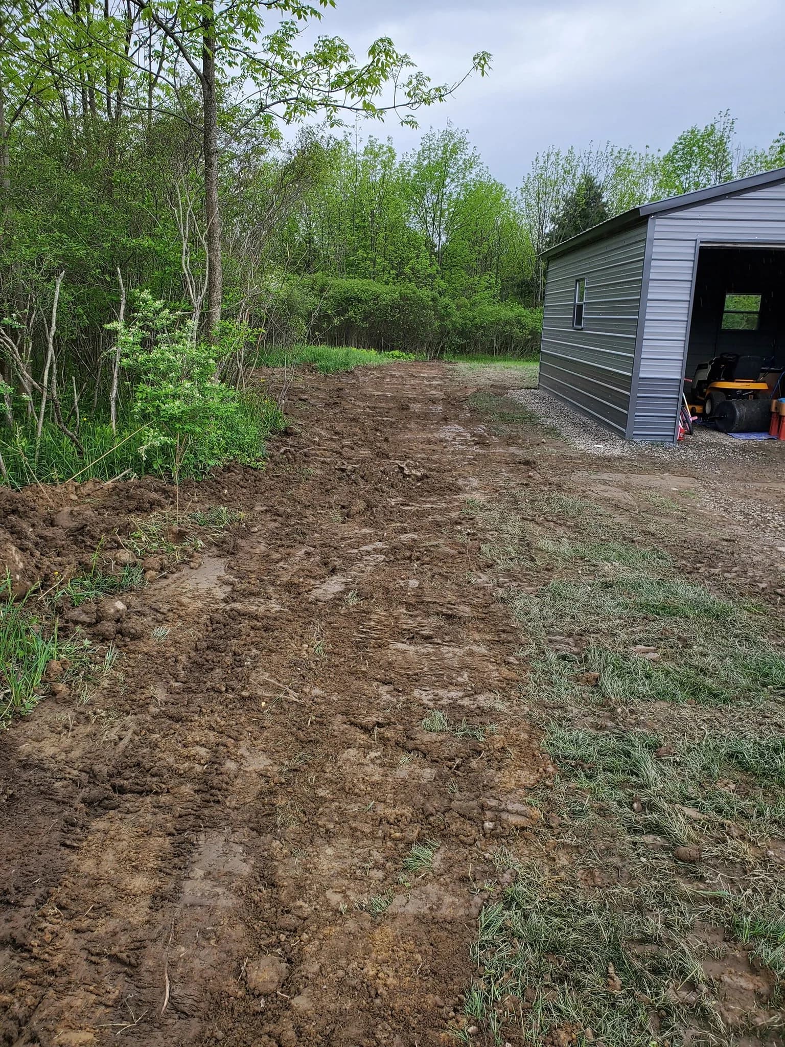 Muddy tracks from equipment in Orchard Park side yard post-excavation